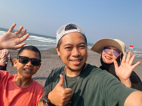 Selfie Portrait of Family at The Beach Under The Blue Sky at Summertime