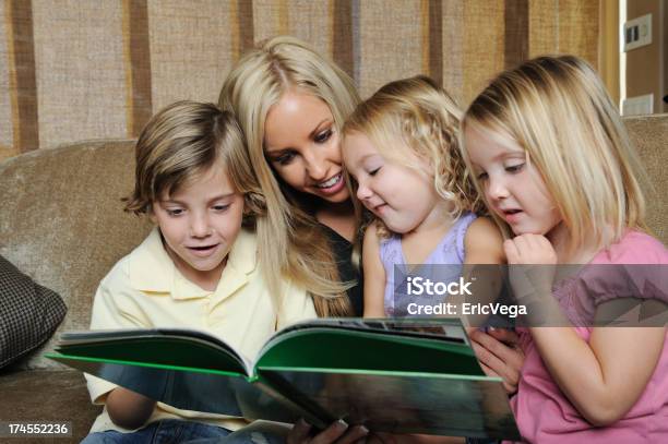 Mother Reading To Her Children Stock Photo - Download Image Now - Child, Reading, Family with Three Children