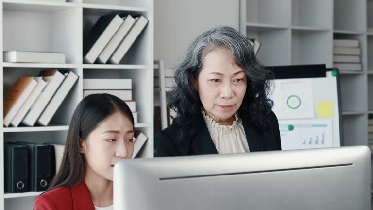 Senior businesswoman has work meeting with employees in the finance department, senior female leaders in organization, company financial planning meeting. Concept of meeting together in the company.