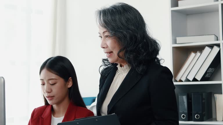 Senior businesswoman has work meeting with employees in the finance department, senior female leaders in organization, company financial planning meeting. Concept of meeting together in the company.