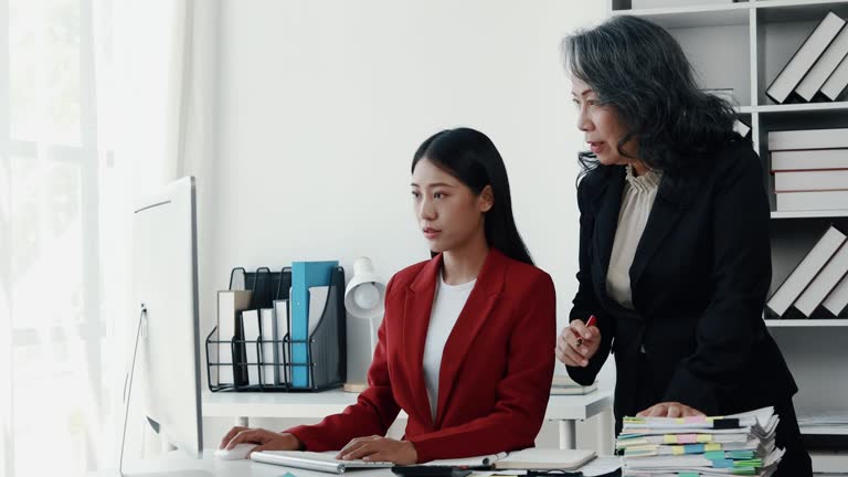 Senior businesswoman has work meeting with employees in the finance department, senior female leaders in organization, company financial planning meeting. Concept of meeting together in the company.