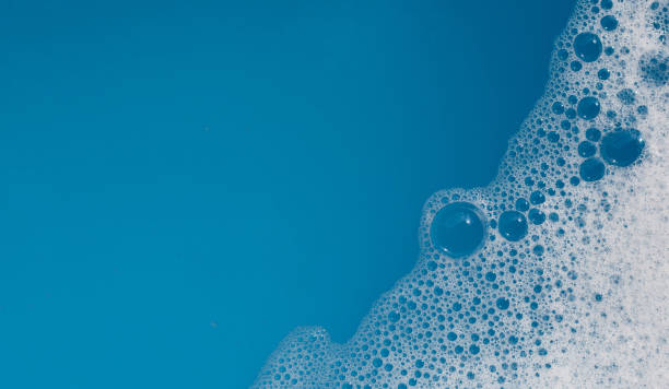 istock Detergent foam bubble on water. Blue background, Soap sud 1745562693