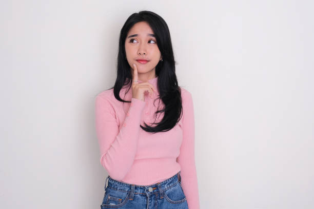 istock Young Asian woman looking to the right side thinking about something 1745563736