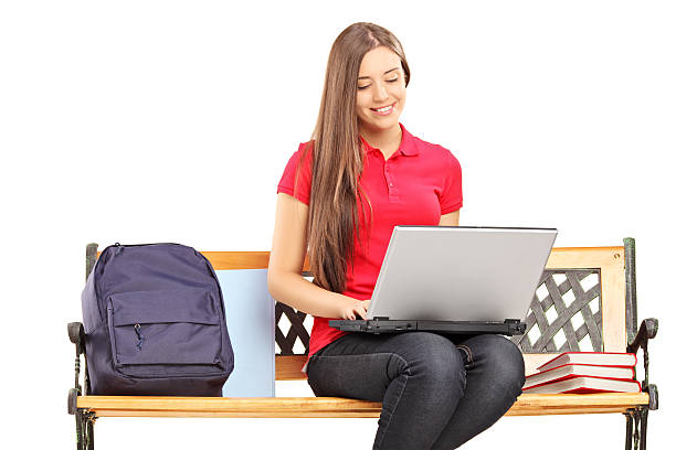 istock Smiling female student sitting and working on a laptop 174556535