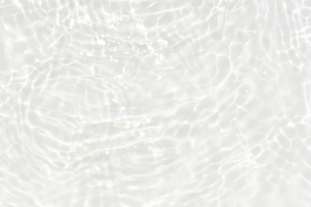 istock Defocus blurred transparent blue colored clear calm water surface texture with splashes reflection. Trendy abstract nature background. Water waves in sunlight with copy space. Blue watercolor shine. 1745586585