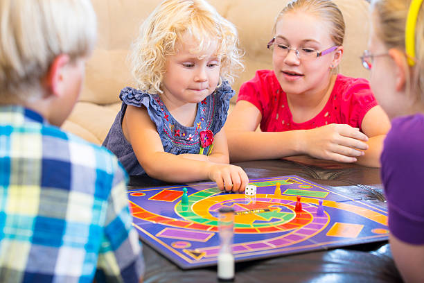 istock Group of kids playing a board game 174559329