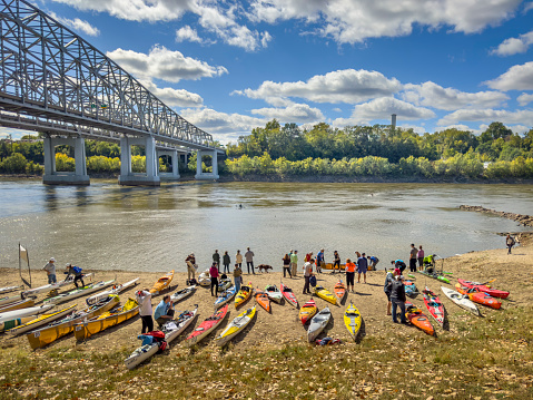 Jefferson City, MO, USA - October 7, 2023: Paddlers with kayaks and canoes at race finish on a beach of the Missouri River at Wilson Serenity Point (Noren River Access).