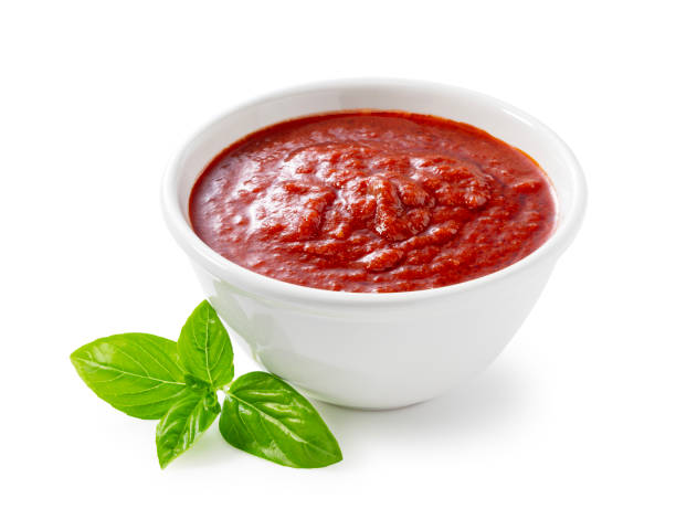 istock Tomato sauce and basil in a white bowl against a white background. 1745611771