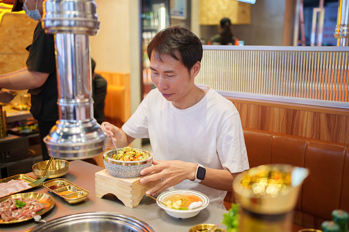Man eating Korean food