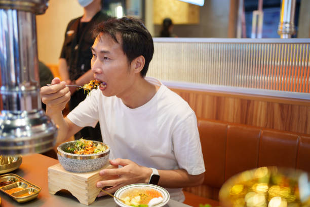istock Man eating Korean bibimbap 1745649709