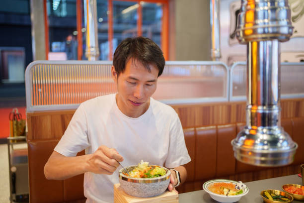 istock Man eating Korean bibimbap 1745650746