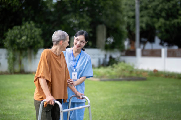 istock Nurse or caregiver hand on walking frame for support, help or trust moving leg in rehabilitation. Physiotherapy healthcare, Medical caregiver consulting disabled elderly patient at home 1745653357