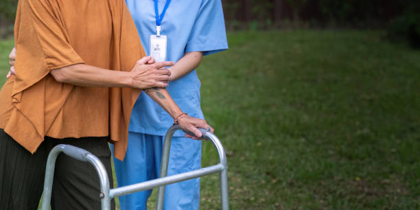 istock Nurse or caregiver hand on walking frame for support, help or trust moving leg in rehabilitation. Physiotherapy healthcare, Medical caregiver consulting disabled elderly patient at home 1745655431