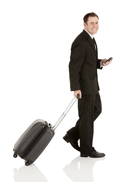 istock Businessman with a trolley bag and mobile phone 174565667