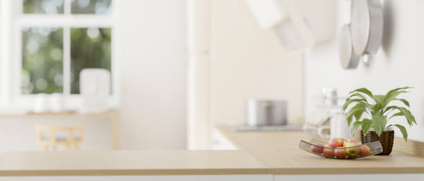 istock Empty mockup space on a wooden kitchen countertop in a modern bright kitchen. close-up image 1745672099