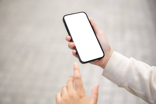 istock Close-up image of a woman using her smartphone while walking down the street. 1745674742