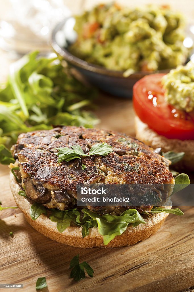 Homemade Organic Vegetarian Mushroom Burger Homemade Organic Vegetarian Mushroom Burger with tomato and guacamole Avocado Stock Photo