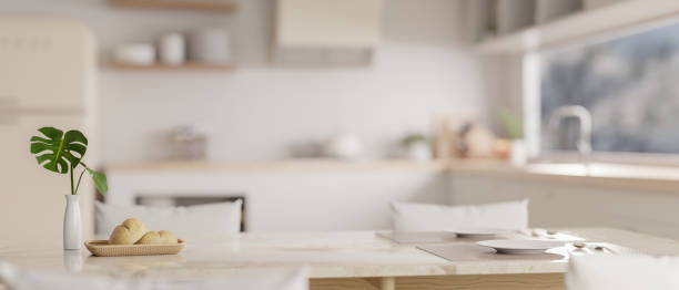 istock Close-up image of sets of tableware on a luxury white marble dining table in a modern white kitchen. 1745683049