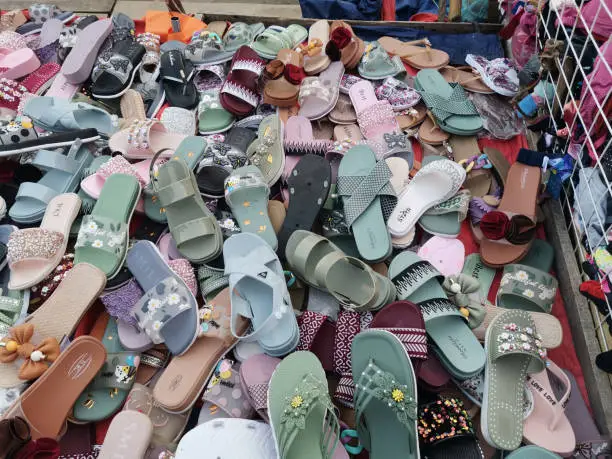 In the bustling streets of Dhaka, Bangladesh, where the vibrant tapestry of daily life unfolds, you'll come across a street market adorned with an array of stylish ladies' sandals and slippers.