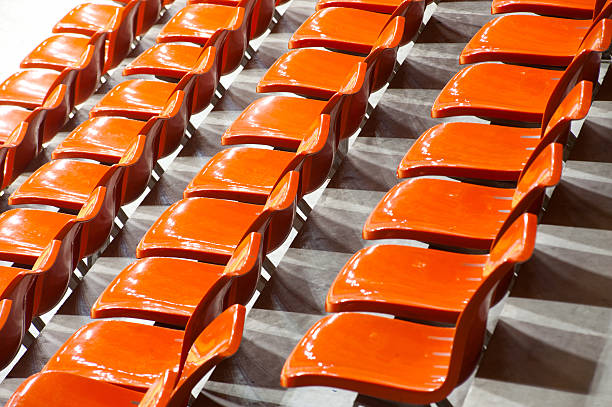 istock Plenty of orange  plastic seats at stadium . 174569256
