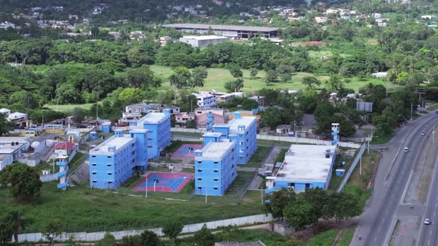 Sideways aerial of big cell blocks of a Jail in the Caribbean Dominican republic