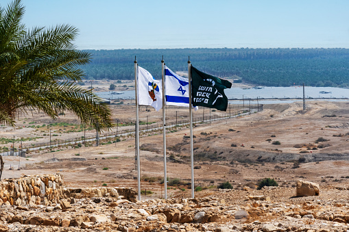 Qumram, Judean desert, Israel - August 13, 2023: Flags at Qumran National Park where the dead sea scrolls were found.