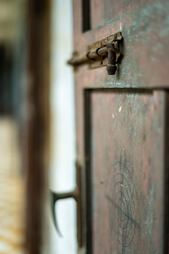 A captivating stock image capturing the timeless appeal of a rustic door, enhanced by a well-worn and rusty slide lock. The photograph conveys a sense of character and history, invoking the enduring charm of a bygone era.

In this image, the rusty slide lock stands as a testament to the door's long-standing presence and purpose. The weathered wood and aged elements of the door create an ambiance that speaks of authenticity and a connection to the past.

This photograph is a versatile asset for various creative projects that seek to convey the vintage and rustic allure of a location or the historical details that contribute to its unique character.