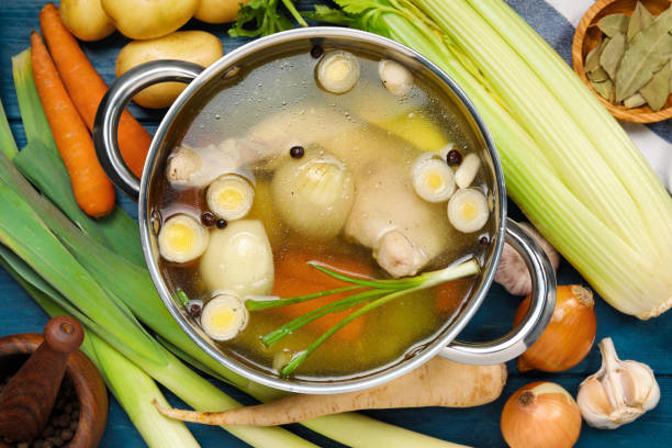 istock Pot with tasty bouillon and different ingredients on blue wooden table, flat lay 1745756648