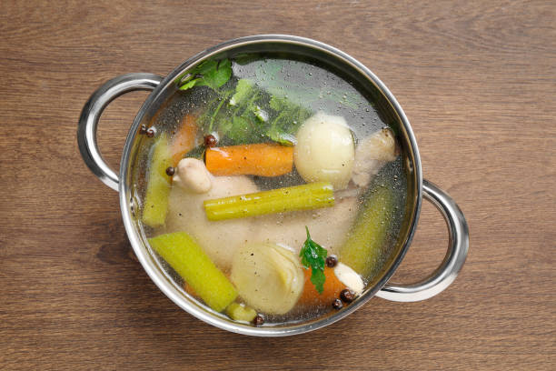 istock Pot with tasty bouillon on wooden table, top view 1745758767