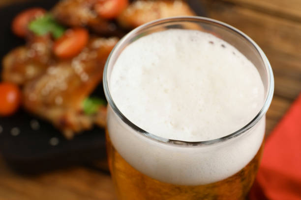istock Glass of fresh beer on table, closeup view 1745760910