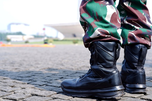 Army soldier boots. Military wearing black tactical boots