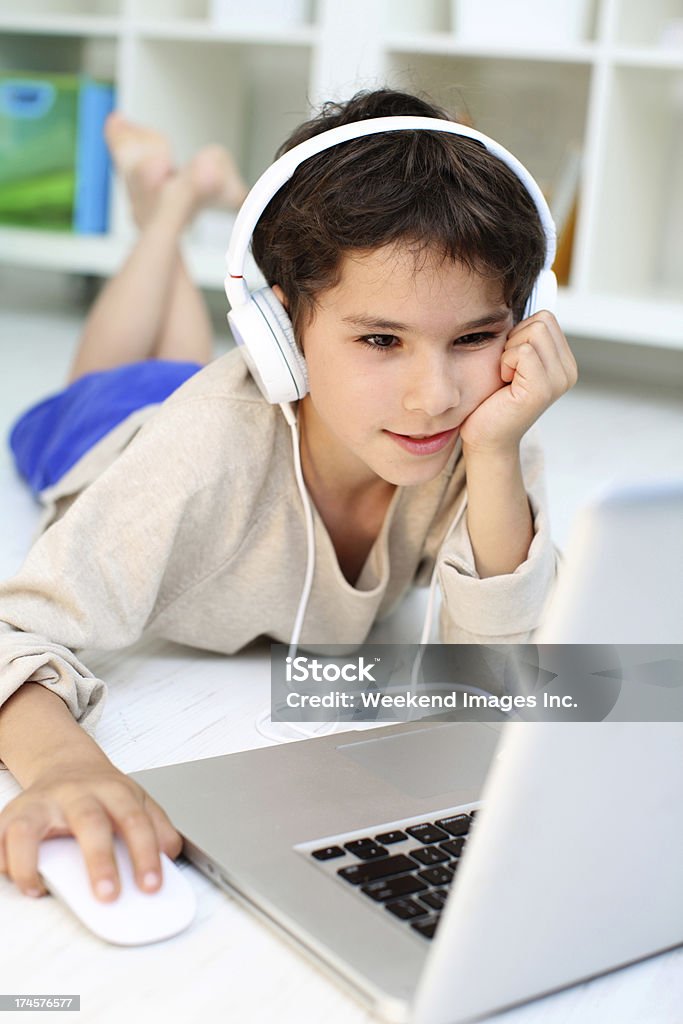 New audible course Elementary age student listening on-line tutor 8-9 Years Stock Photo