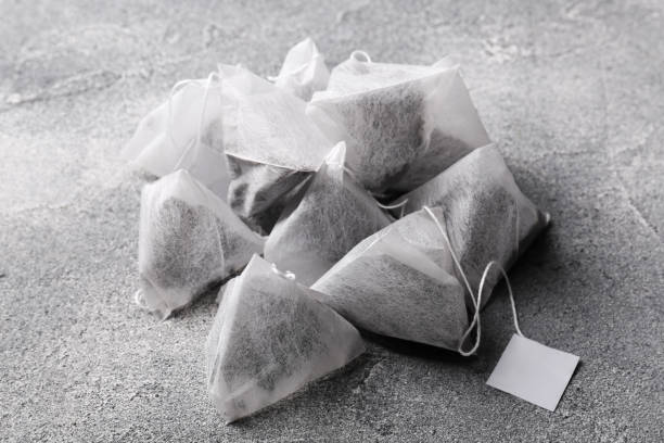 istock Tea bags with tabs on light grey table, closeup 1745766283
