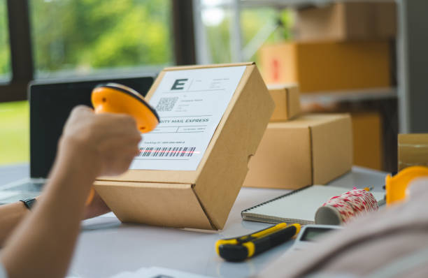 istock online small business owner scans a barcode-labeled parcel with a barcode scanner to verify a customer's order before it is delivered to the customer. 1745768385
