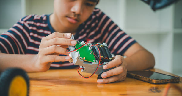 istock Asian boy learning and studying the work of technology robots.homeschool and science for tech project. playing childhood kids hobby leisure lifestyle people toys robotics technology. 1745769882