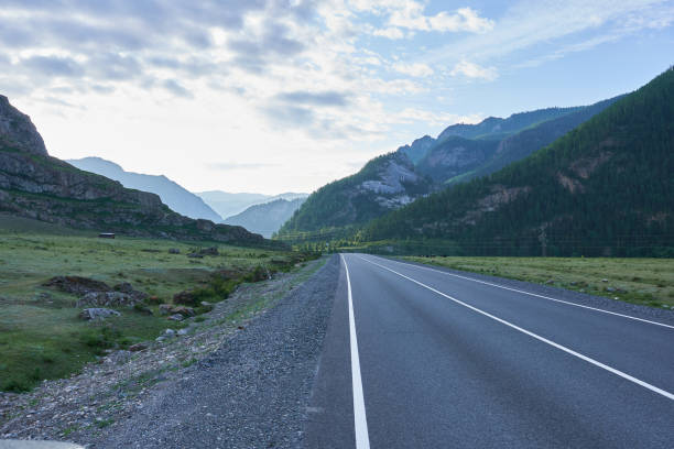 istock A road in the mountains at dawn. Mountain Altai. 1745770011