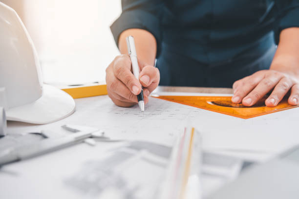 istock engineer working in office with blueprints, inspection in workplace for architectural plan, construction project ,Business construction 1745771149