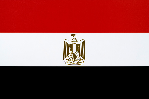 Close-up on a paper flag of Egypt with light effect and vignette. Visible paper texture for super realistic effect. Selective focus. Canon 5D Mark II and Sigma lens.SEE MORE STATE FLAGS BELOW: