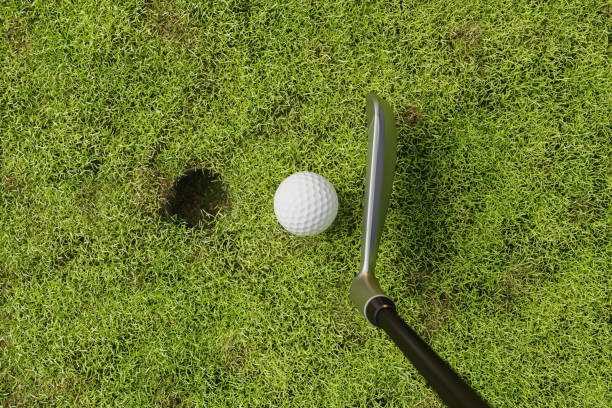 High Angle View Of Golf Ball, Putter And Hole On Golf Course