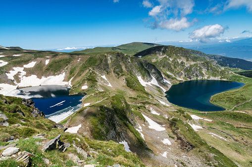 A breathtaking view of the Seven Rila Lakes, nestled in the heart of the Rila Mountains in Bulgaria, showcasing pristine turquoise waters and rugged mountains.