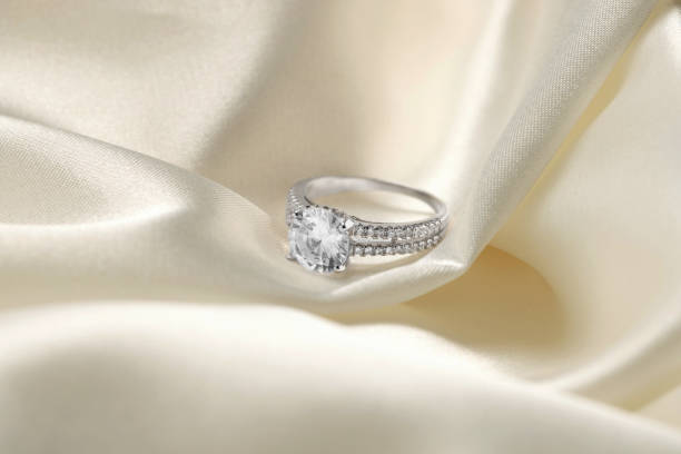 istock Beautiful ring with gemstones on white fabric. Luxury jewelry 1745829633