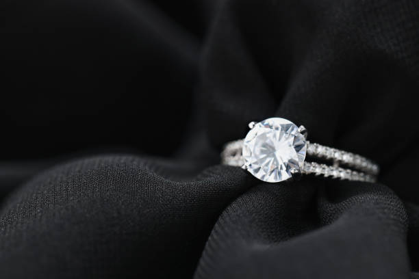 istock Beautiful ring with gemstones on black fabric, space for text. Luxury jewelry 1745830154