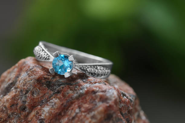 istock Beautiful ring with light blue gemstone on stone, closeup. Luxury jewelry 1745830712
