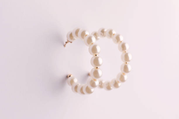 istock Elegant earrings with pearls on white background 1745831279