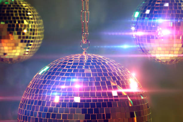 istock Shiny bright disco balls on under color lights 1745831482