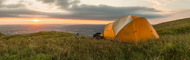 istock Wild camp tent on grassy summer mountain overlooking valley sunset 174583664