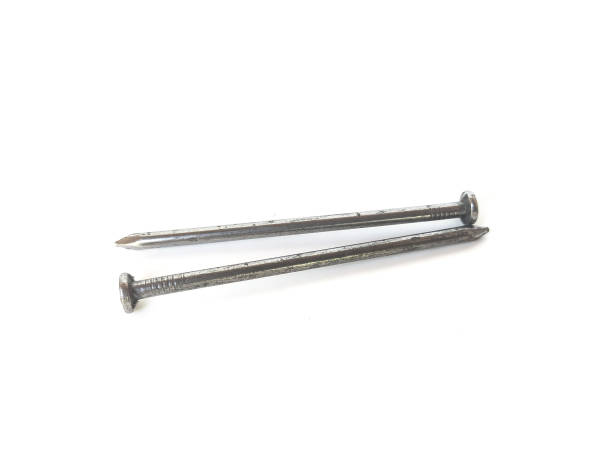 istock Woodworking nails, nail number 3, laying on a white background. 1745838916