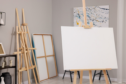 Artist's studio with easels, canvases and painting supplies