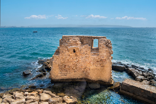 Pisan harbour, harbor, in the old town of Akko or Acre, an historic city in northern Israel. Remains of fortress walls and Mediterranean sea.
