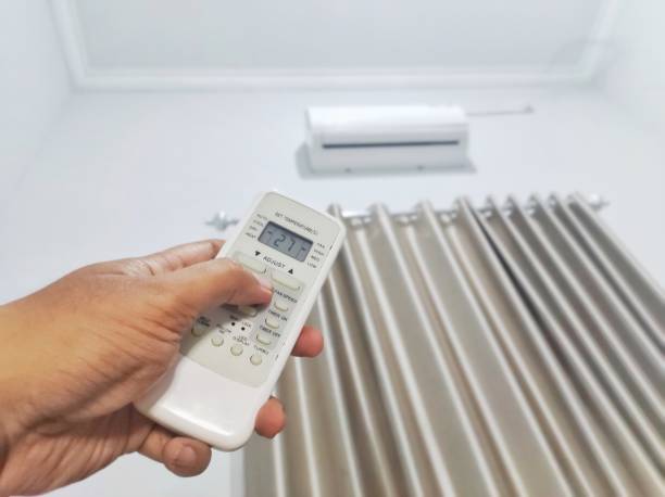 istock Hand Holding Air Conditioner Remote 1745858398